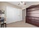 Bedroom displays built-in shelves and a large closet along with neutral walls at 19933 N Emmerson Dr, Maricopa, AZ 85138
