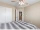 Bedroom features a ceiling fan, closet, and neutral walls with carpet flooring at 19933 N Emmerson Dr, Maricopa, AZ 85138