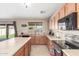 Spacious kitchen featuring stainless steel appliances, ample counter space, and a sliding back door at 19933 N Emmerson Dr, Maricopa, AZ 85138
