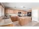 Well-lit kitchen offers ample countertop space, a functional island, and stainless appliances at 19933 N Emmerson Dr, Maricopa, AZ 85138