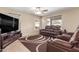Comfortable living room with plush seating, a ceiling fan and a large television at 19933 N Emmerson Dr, Maricopa, AZ 85138