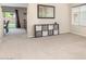 Spacious living area featuring neutral carpet, a storage shelf and backyard access at 19933 N Emmerson Dr, Maricopa, AZ 85138