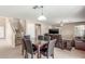 Open concept living room and staircase featuring a dining table with marble top at 19933 N Emmerson Dr, Maricopa, AZ 85138
