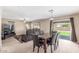Open floor plan with a cozy living room, marble-top dining table, and backyard access at 19933 N Emmerson Dr, Maricopa, AZ 85138