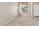 Bright living room with neutral carpet and large windows at 19933 N Emmerson Dr, Maricopa, AZ 85138