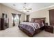 Cozy main bedroom with a ceiling fan and a window providing natural light at 19933 N Emmerson Dr, Maricopa, AZ 85138