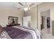 Bright main bedroom with ceiling fan, closet, and attached bath at 19933 N Emmerson Dr, Maricopa, AZ 85138