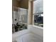 Bright bathroom features a shower with glass enclosure, garden tub, and a window with natural light at 20230 N Jill Ave, Maricopa, AZ 85138