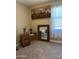 Neutral bedroom with a large window, woven wall hanging, and a wooden dresser with decor at 20230 N Jill Ave, Maricopa, AZ 85138