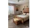 Bright bedroom featuring a wooden bed frame, natural lighting, and window coverings at 20230 N Jill Ave, Maricopa, AZ 85138