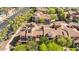 Aerial view of a residential area featuring red tile roofs, lush trees, and well-maintained streets at 21109 W Sunrise Ln, Buckeye, AZ 85396