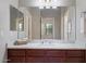 Bathroom featuring a double vanity with granite countertops and a large mirror that enhances the space at 21109 W Sunrise Ln, Buckeye, AZ 85396