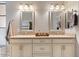 Bathroom featuring double sinks, granite counters, and decorative mirrors at 21109 W Sunrise Ln, Buckeye, AZ 85396