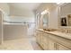 Bathroom with walk-in shower, tile flooring, and double sink vanity at 21109 W Sunrise Ln, Buckeye, AZ 85396