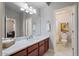 Bright bathroom with a large mirror, white marble floors, and a separate toilet room, enhancing functionality at 21109 W Sunrise Ln, Buckeye, AZ 85396