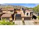Exterior shot of homes with three-car garages, solar panels, and desert landscaping against a mountain backdrop at 21109 W Sunrise Ln, Buckeye, AZ 85396