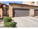 Large two-car garage with a wide driveway and desert landscaping, complemented by an address number above at 21109 W Sunrise Ln, Buckeye, AZ 85396
