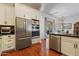 Modern kitchen features stainless steel appliances and sleek white cabinetry with black hardware at 21109 W Sunrise Ln, Buckeye, AZ 85396