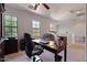 Bright home office with large windows, custom built-in drawers, and a comfortable workspace at 21109 W Sunrise Ln, Buckeye, AZ 85396