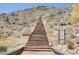 A straight stone stairway ascends a desert mountain landscape, offering community access and outdoor activities at 21109 W Sunrise Ln, Buckeye, AZ 85396