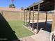 Backyard patio features artificial turf and a shaded structure at 2130 W Devonshire St, Mesa, AZ 85201