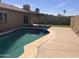 Backyard pool features a covered patio and artificial turf lawn at 2130 W Devonshire St, Mesa, AZ 85201