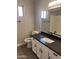 Bright bathroom featuring dark countertop and white cabinets at 2130 W Devonshire St, Mesa, AZ 85201