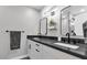 Modern bathroom features dual sinks, sleek black fixtures, and stylish mirrors at 2130 W Devonshire St, Mesa, AZ 85201