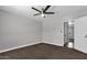 Bedroom features ceiling fan and neutral carpet at 2130 W Devonshire St, Mesa, AZ 85201