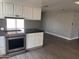 Updated kitchen featuring an island with counter seating, stainless steel oven, and white cabinetry at 2130 W Devonshire St, Mesa, AZ 85201