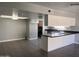 Open kitchen with a large island, stainless steel appliances, and seamless access to the laundry room at 2130 W Devonshire St, Mesa, AZ 85201