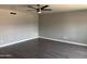 Spacious room with fresh paint, modern flooring, ceiling fan and well-lit space at 2130 W Devonshire St, Mesa, AZ 85201