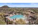 Aerial view showcases the large community pool and spa, surrounded by well-maintained desert landscaping at 2145 N 88Th St, Mesa, AZ 85207