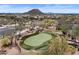 Aerial view of the community featuring a putting green, walking path, and desert landscaping at 2145 N 88Th St, Mesa, AZ 85207