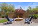 Backyard patio with a cozy fire pit and shaded seating area at 2145 N 88Th St, Mesa, AZ 85207