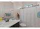 Bright bathroom with a shower curtain, dark cabinets, and a white sink at 2145 N 88Th St, Mesa, AZ 85207