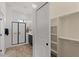 This bright bathroom features a glass-door shower, dark cabinets, and a closet with a white sliding door at 2145 N 88Th St, Mesa, AZ 85207