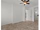 Bright bedroom with neutral walls, tile floors, and hallway entrance at 2145 N 88Th St, Mesa, AZ 85207