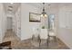 Bright dining area features a modern chandelier, white furniture, and plenty of natural light at 2145 N 88Th St, Mesa, AZ 85207