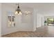 Cozy dining room with decorative chandelier, neutral paint, tiled floor, and natural light at 2145 N 88Th St, Mesa, AZ 85207
