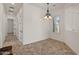 Dining area featuring elegant chandelier, neutral paint, tiled floor, and natural light at 2145 N 88Th St, Mesa, AZ 85207