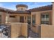 Inviting front entrance with secure gated courtyard with decorative metalwork and stucco wall at 2145 N 88Th St, Mesa, AZ 85207
