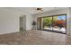 Bright open living area with large sliding glass doors overlooking landscaped patio with fire pit at 2145 N 88Th St, Mesa, AZ 85207