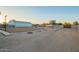 Wide backyard with trees around perimeter, and a steel building at 22626 W Gibson Ln, Buckeye, AZ 85326