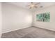 Bright bedroom features neutral tones, natural light, and a ceiling fan at 22626 W Gibson Ln, Buckeye, AZ 85326