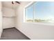 Bright bedroom featuring a large window, neutral paint, and soft carpeting at 22626 W Gibson Ln, Buckeye, AZ 85326