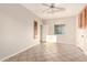 Versatile bonus room with tile flooring, bright light and a ceiling fan offering endless possibilities and great potential at 22626 W Gibson Ln, Buckeye, AZ 85326