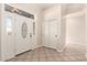 Bright foyer featuring tile floors, a decorative door, and closet at 22626 W Gibson Ln, Buckeye, AZ 85326