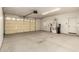 An open garage with a large garage door, water heater, and storage space at 22626 W Gibson Ln, Buckeye, AZ 85326