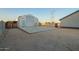 Exterior of a versatile metal garage building with a concrete pad and basketball hoop on a desert lot at 22626 W Gibson Ln, Buckeye, AZ 85326